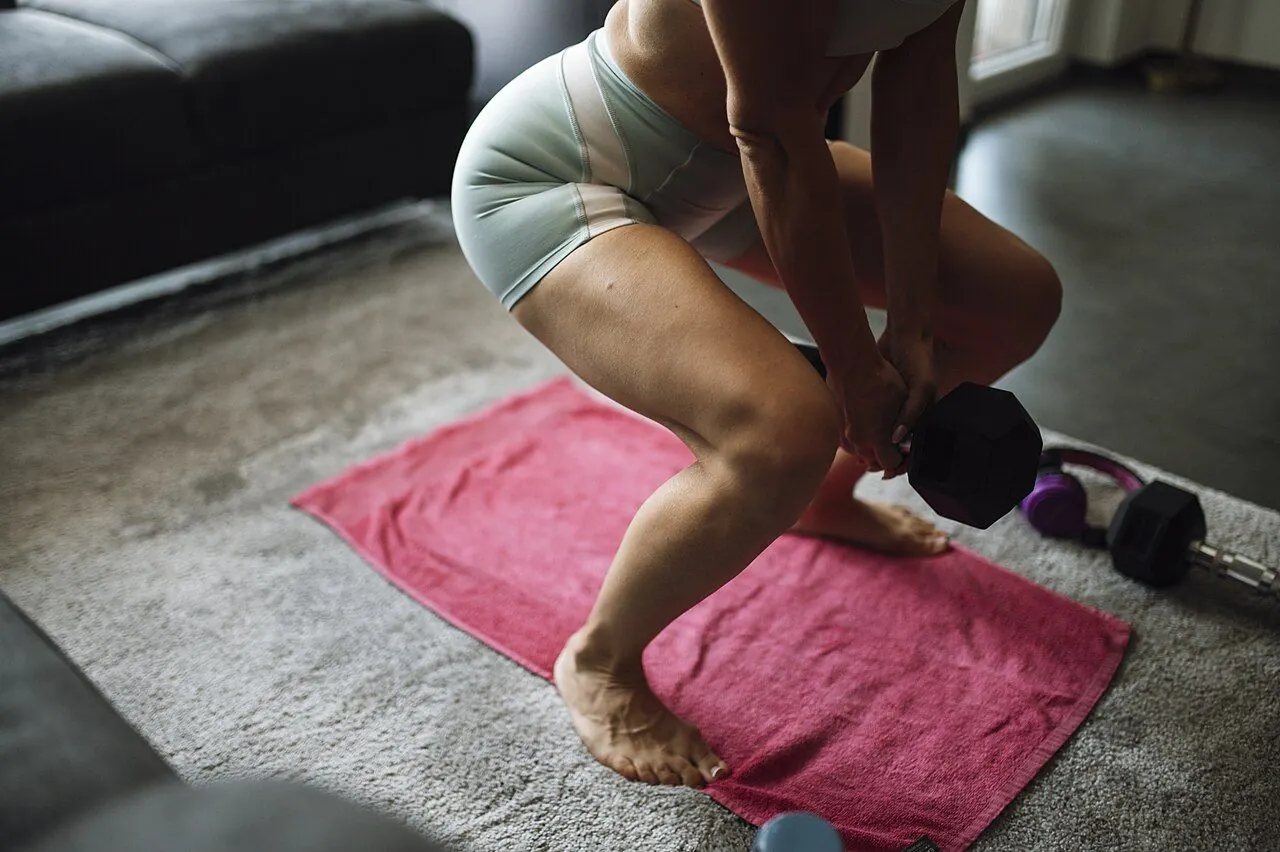 Person doing a glute bridge on a living room floor
